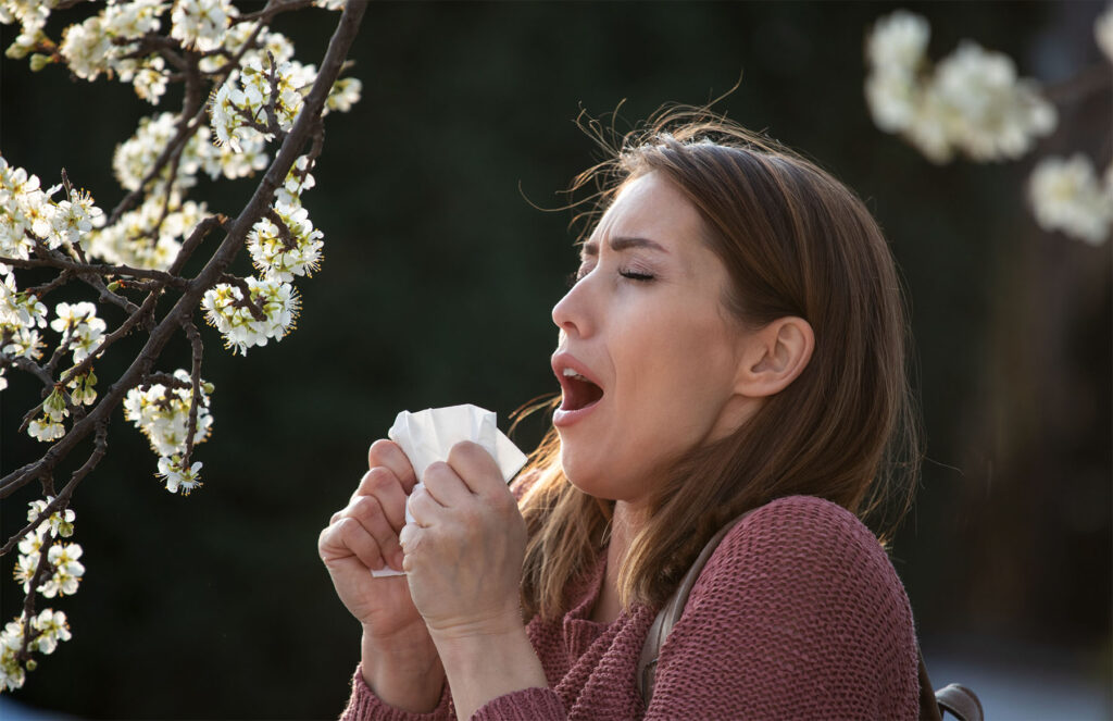 Screenshot Person experiencing common allergy symptoms like sneezing, congestion, and itchy eyes.