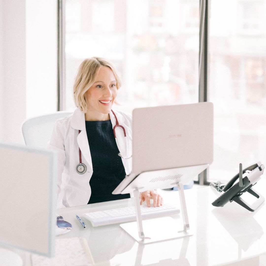 Dr. Tara Campbell, ND, at her desk during a patient consultation